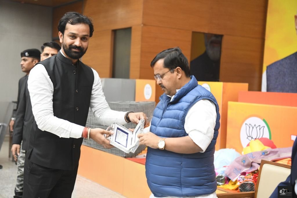 Ankit Bansal presenting a memento at a BJP event in Mathura